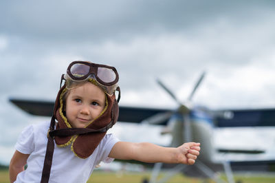 Portrait of cute girl against sky