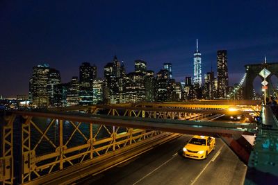 High angle view of yellow taxi on brooklyn bridge at night