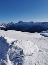 Scenic view of snowcapped mountains against clear blue sky