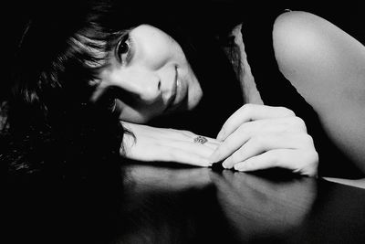 Close-up of woman hand on table at home