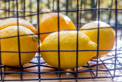 Close-up of yellow lemons in basket