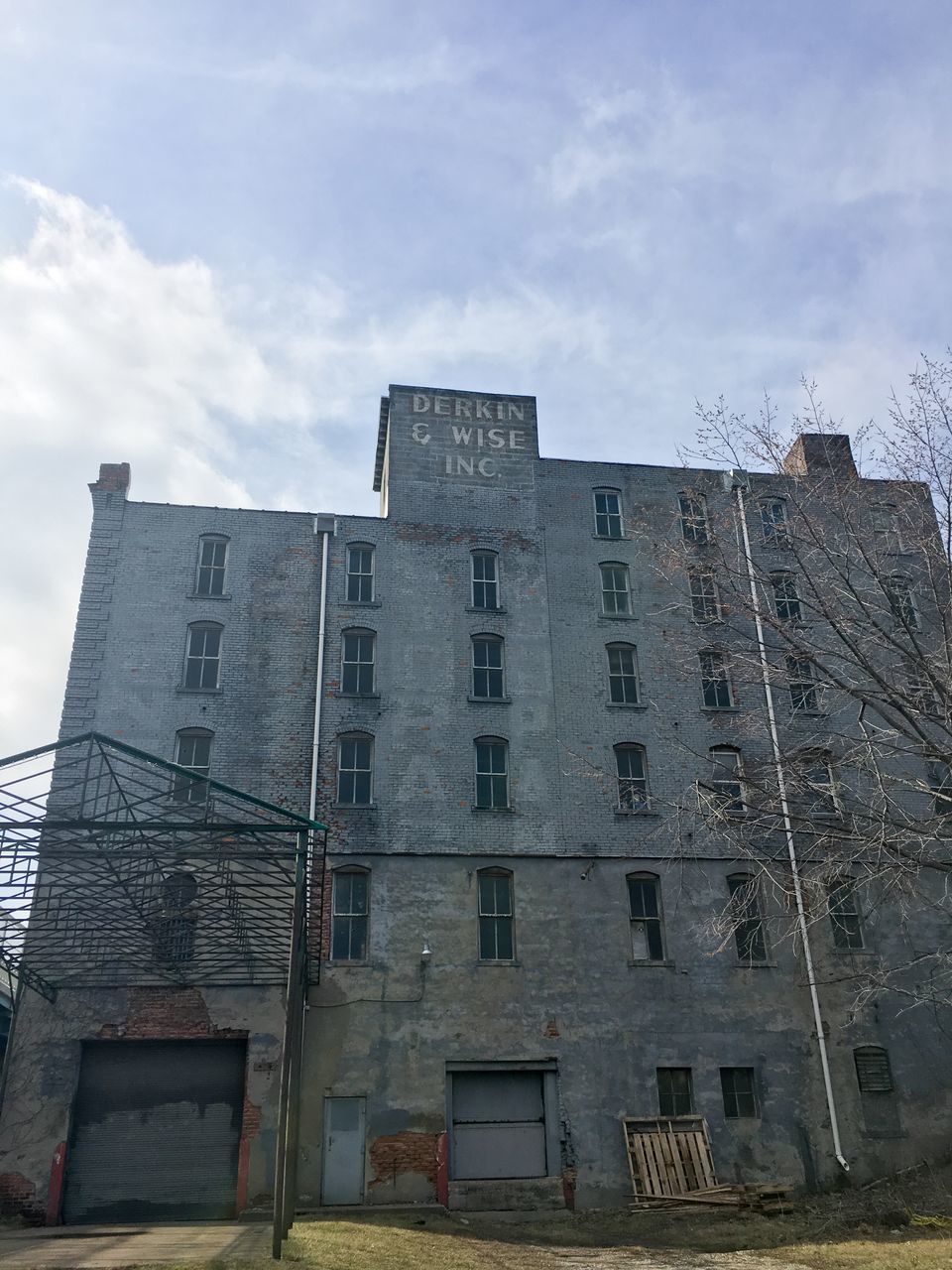 building exterior, architecture, built structure, low angle view, sky, window, building, cloud - sky, residential building, city, residential structure, day, outdoors, cloudy, no people, cloud, brick wall, apartment, house, sunlight