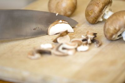 Close-up of knife and mushroom on cutting board