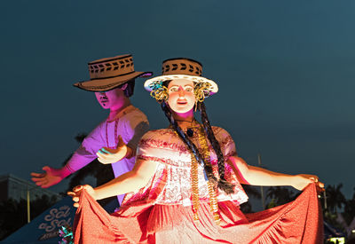 Low angle view of woman dancing against sky