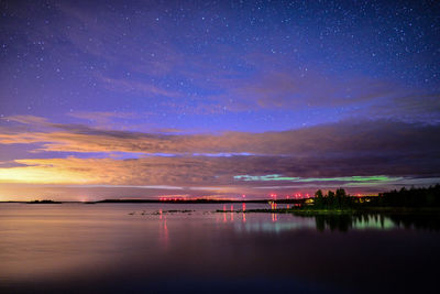 Scenic view of lake against sky at night