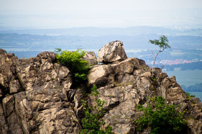 Scenic view of cliff by sea against sky