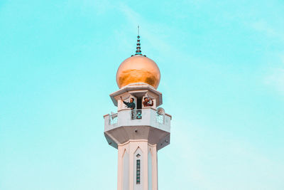 Low angle view of tower and building against sky