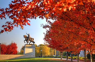 Statue in park during autumn