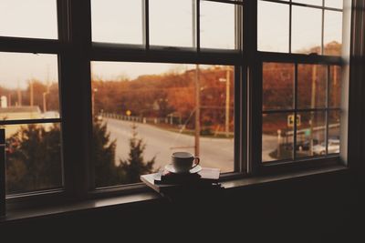 Coffee cup on books indoors