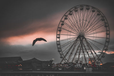 Low angle view of ferris wheel at night