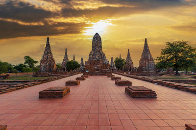 Golden gate of temple against sky during sunset