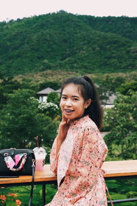 Portrait of smiling girl against plants