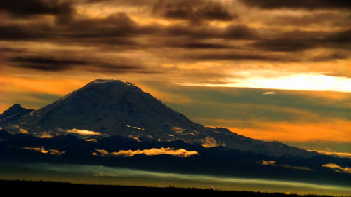 Scenic view of mountains against cloudy sky