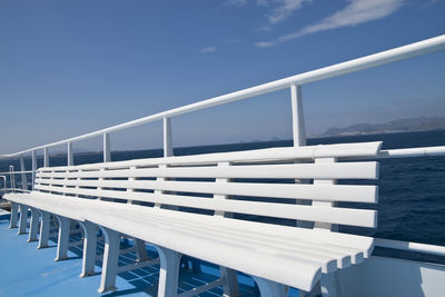 Railing by sea against sky