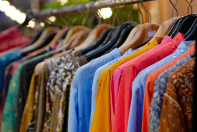 Close-up of clothes hanging for sale