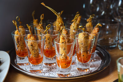 Catering service. fried finger food in sweet chili sauce. appetizers in glasses on the table.