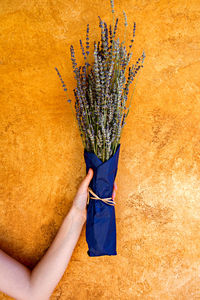 Cropped hand of woman holding flower bouquet