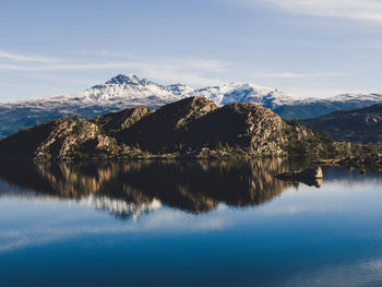 Scenic view of lake and snowcapped mountains against sky