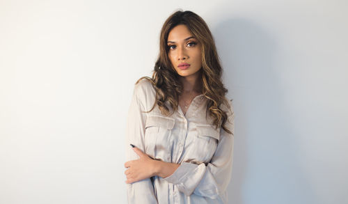 Portrait of a beautiful young woman against white background