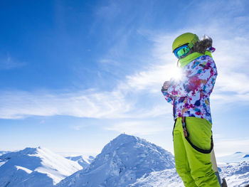 Rear view of woman standing against mountain
