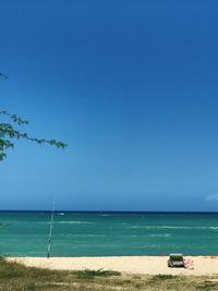 Scenic view of sea against clear blue sky