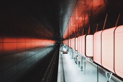 Empty illuminated subway station