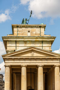 Low angle view of brandenburg gate  against cloudy sky