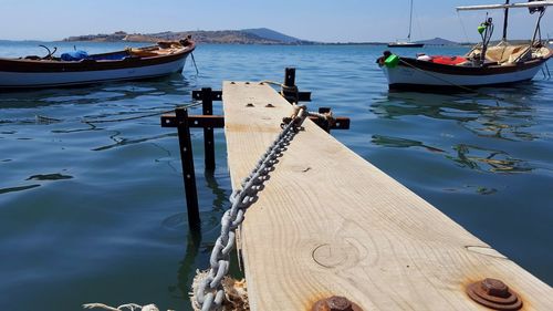 Boats moored on sea against sky