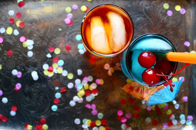 High angle view of cocktails with colorful confetti on table
