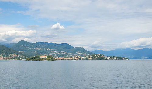 Scenic view of sea and mountains against sky