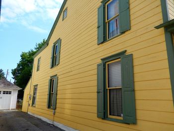 Exterior of yellow house against sky