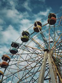 Low angle view of abandoned ferris wheel against sky. old amusement park