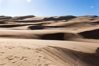 Sand dune in desert against sky