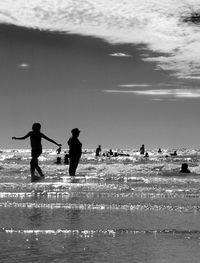 Silhouette people at beach