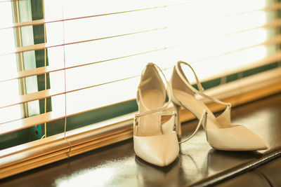 Close-up of high heels on window sill