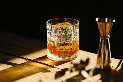 Close-up of glass with bourbon whiskey on table