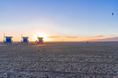 Scenic view of beach against sky during sunset