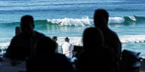 People relaxing on beach