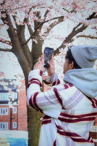 Rear view of woman with arms raised