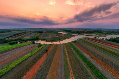 Aerial view of agricultural field against sky during sunset