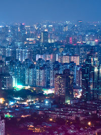 High angle view of illuminated buildings in city at night