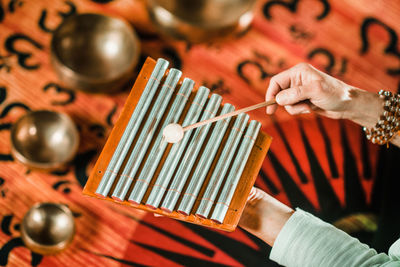 Cropped man playing xylophone during meditation