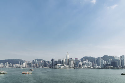 View of boats in sea against buildings in city