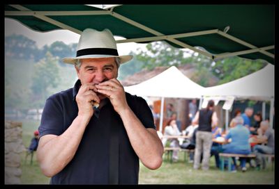 Portrait of man wearing hat standing outdoors