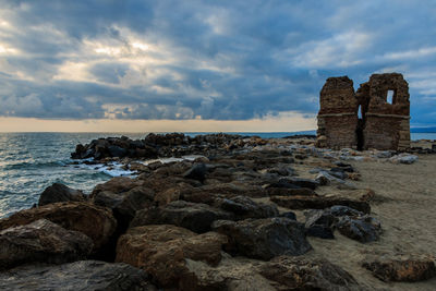 Rocks on beach against sky