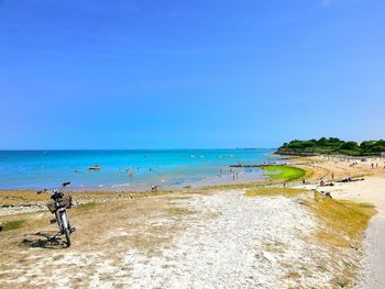 Scenic view of beach against blue sky