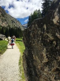 People on mountain road against sky