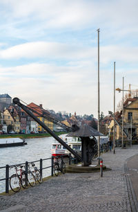 Buildings in city against cloudy sky