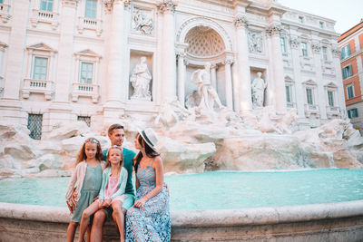 Statue of people in front of building