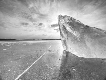 Broken piece of ice floating on frozen sea. scenic view of sea against sky